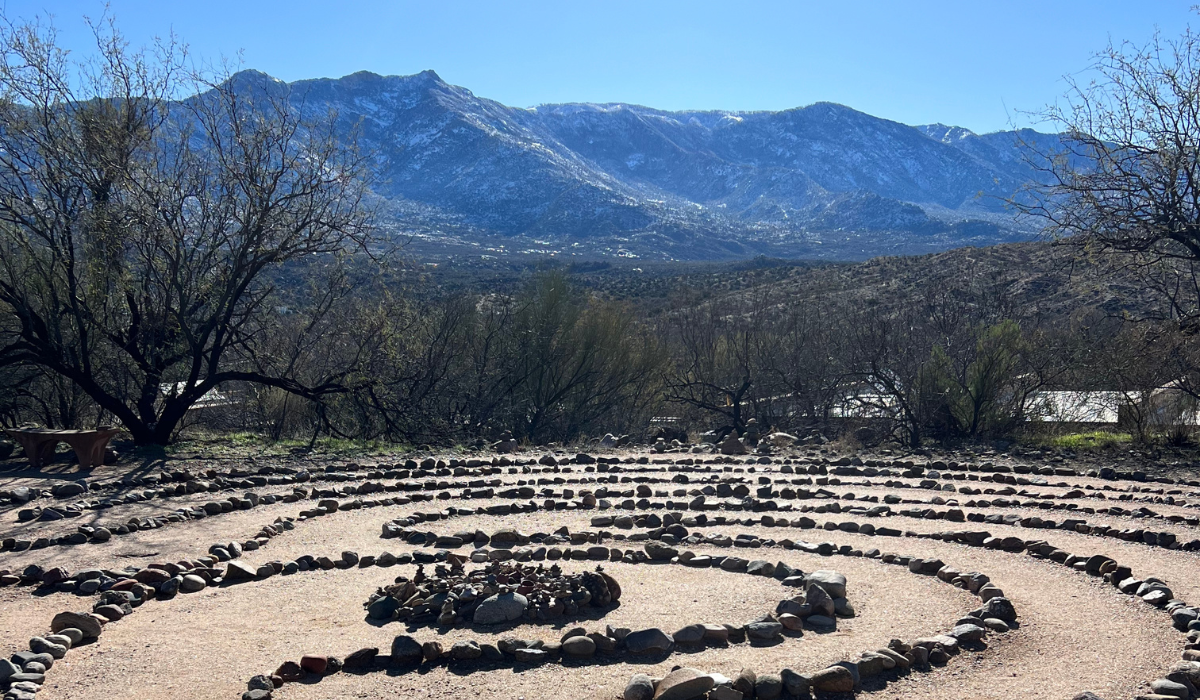  stone labyrinth, mountains and a bright blue sky.