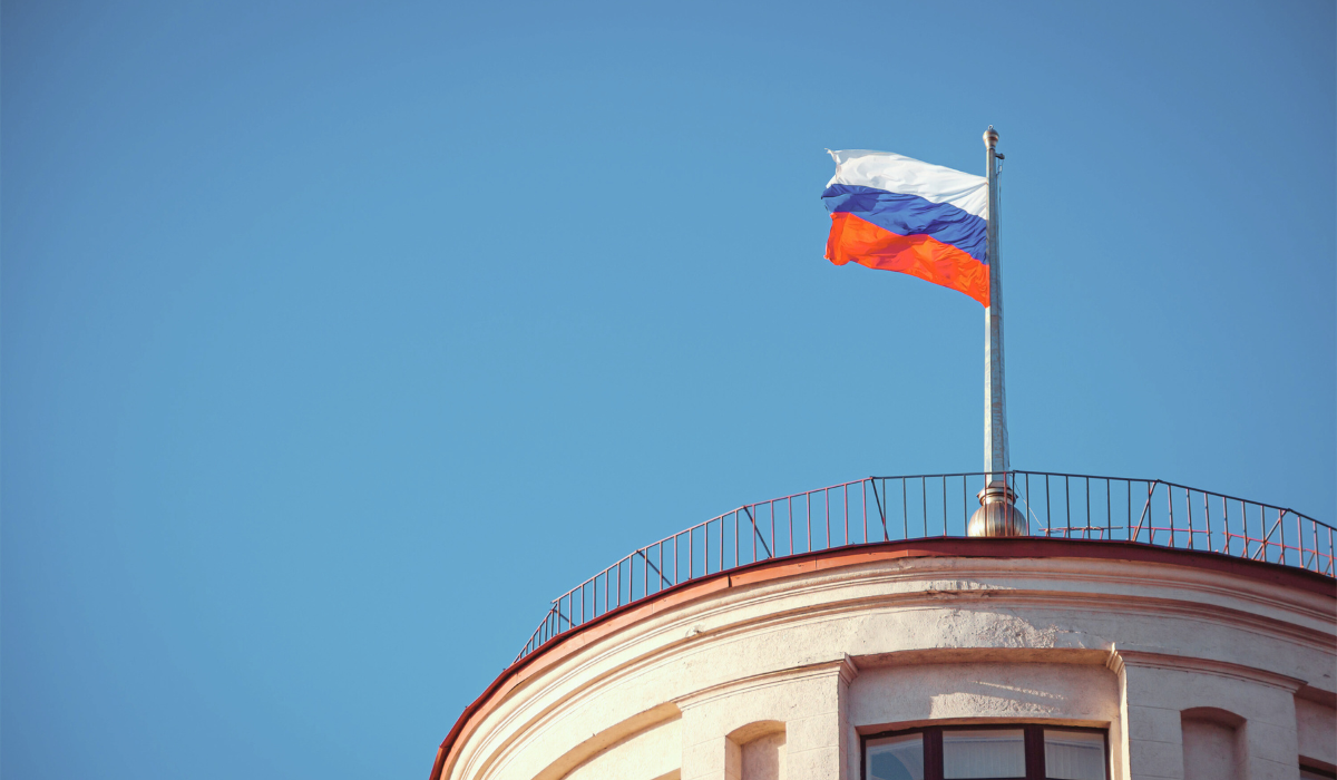 Russian flag over a blue sky.