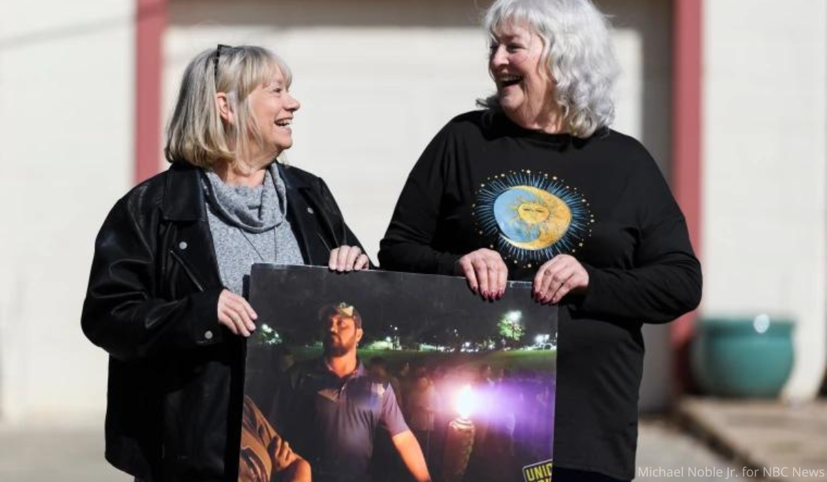 Connie Vickers and Nancy Presnall holding image of Judd Blevins at the 2017 rally in Charlottesville.