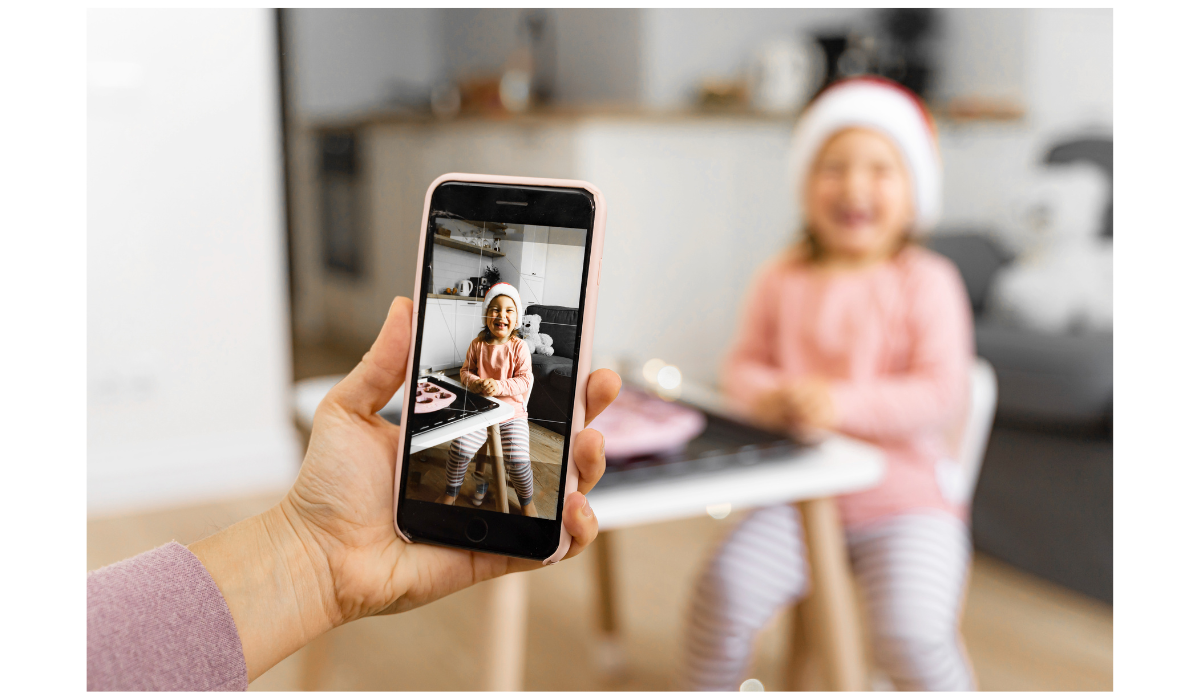 Parent takes picture of child.