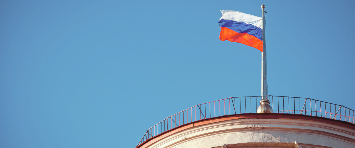 Russian flag over a blue sky.