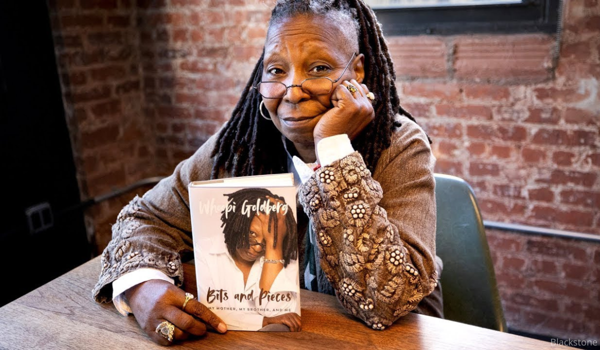 Whoopi Goldberg, holding book Bits and Pieces.