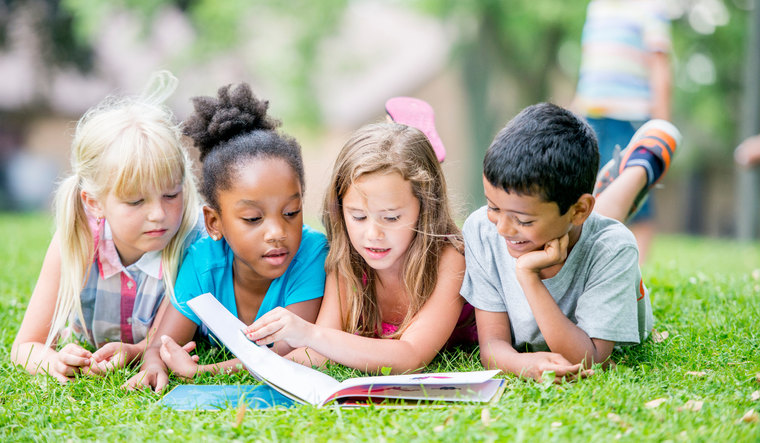 Kids reading a book.
