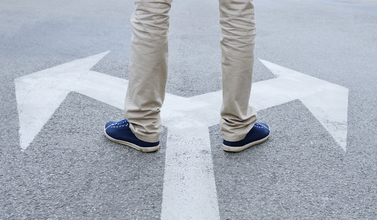 A person stands with arrows pointing in either direction.