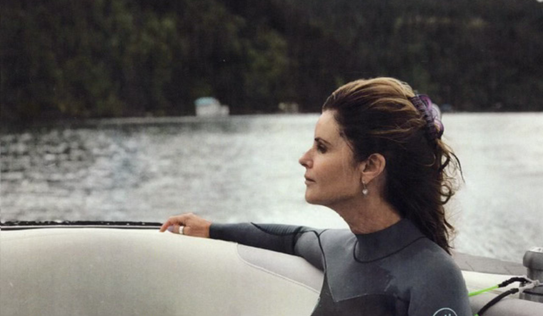 Maria Shriver on a boat in a wet suit.
