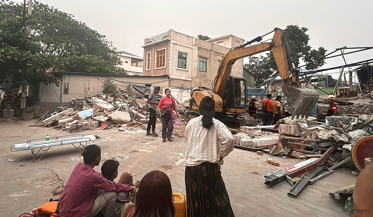 Volunteers work at an earthquake affected area in Mandalay, central Myanmar, Saturday, March 29, 2025.