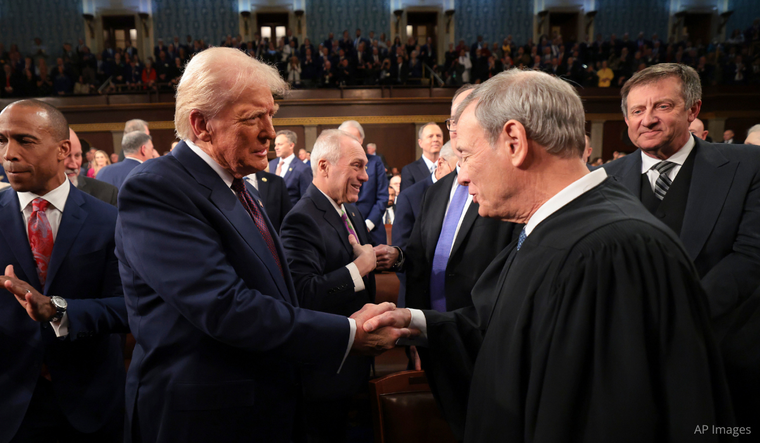 President Donald Trump greets Chief Justice of the Supreme Court John Roberts as he arrives to address a joint session of Congress March 4, 2025.