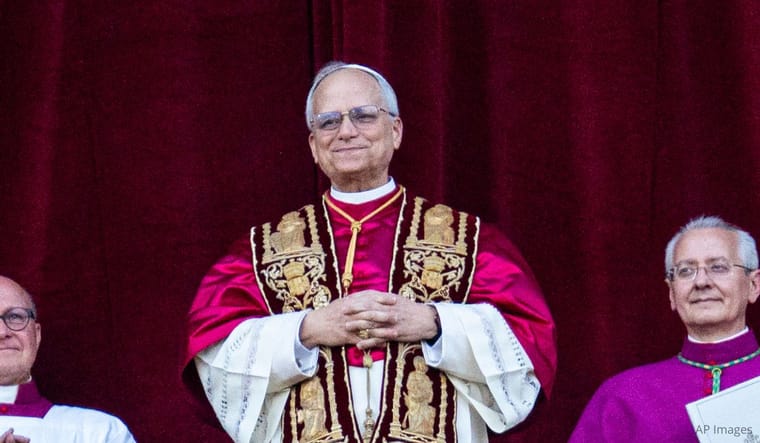Newly elected Pope Leo XIV, Robert Prevost, arrives on the main central loggia balcony of St. Peter's Basilica for the first time on May 8, 2025. (Photo by Massimo Valicchia/NurPhoto via AP).
