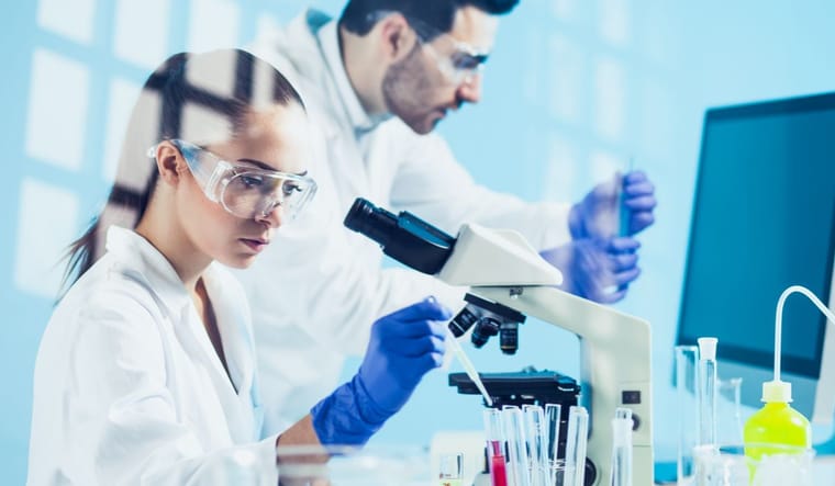 Two people in a research lab with test tubes.