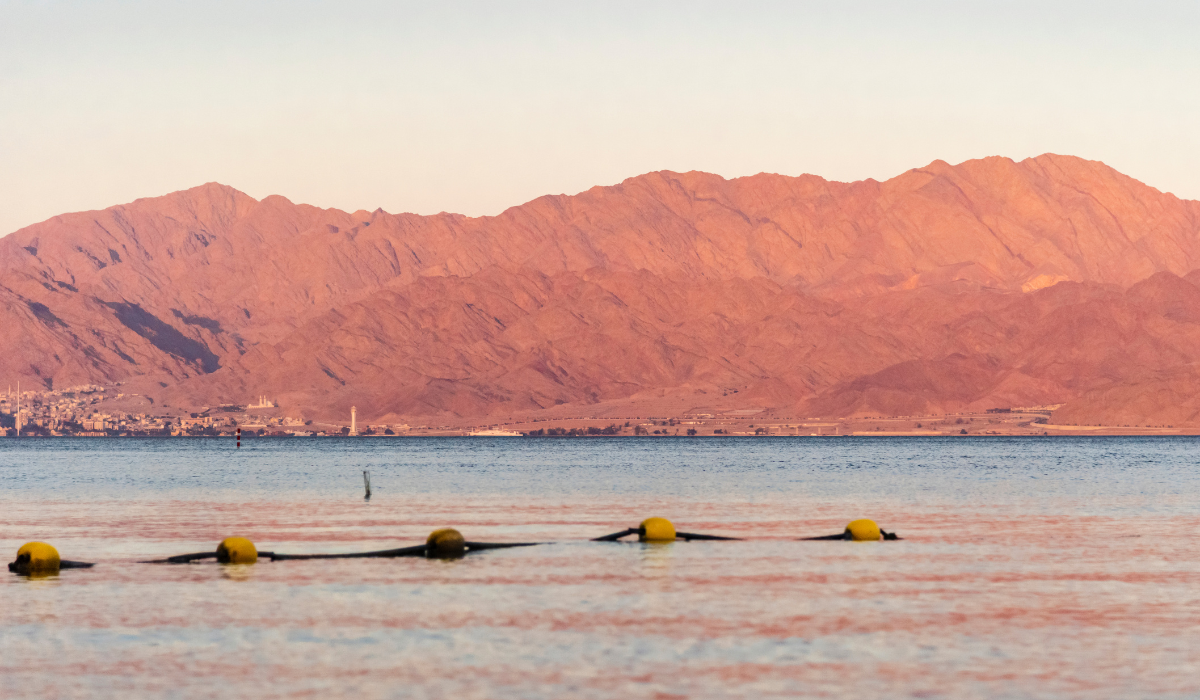 Sunset over the Red sea with pink orange mountains on the background.